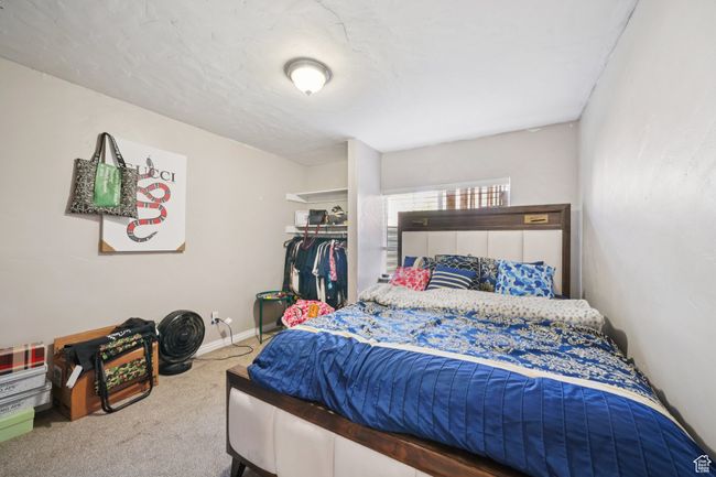 Bedroom with carpet flooring and a closet | Image 19