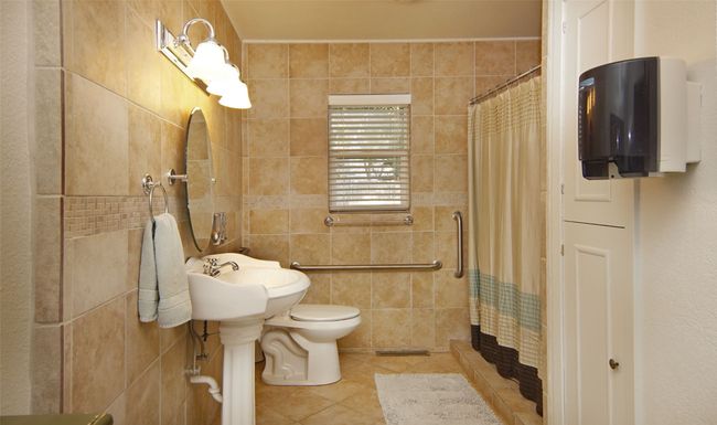 Hallway bath is appointed with aid-assistance bars | Image 21