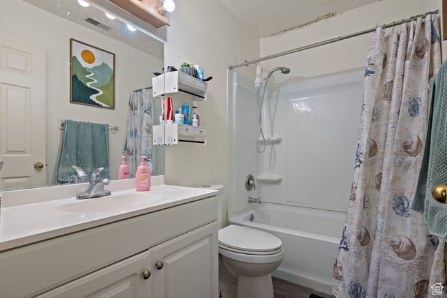 Bathroom with vanity, shower / tub combo, and wood finished floors | Image 43