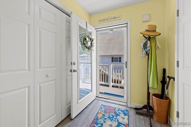Side entry into area that has the elevator opening and the laundry behind bifold doors. | Image 5