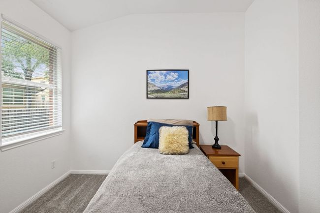 Bedroom with carpet floors and vaulted ceiling | Image 26