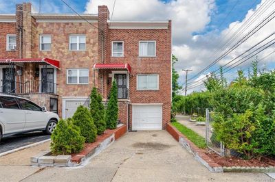 Townhome / multi-family property with a garage | Image 1