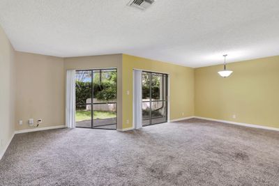 HUGE living room opens to screened, covered patio. Great for entertaining! | Image 3