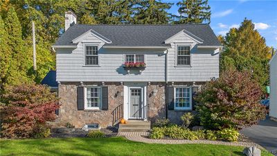 Welcome to 303 Lansdowne Road! This charming DeWitt home is as attractive on the inside as it is on the outside! The main level adorned in stone, and the handsome dormers on the second floor bring a wonderful New England feel to the design. | Image 1