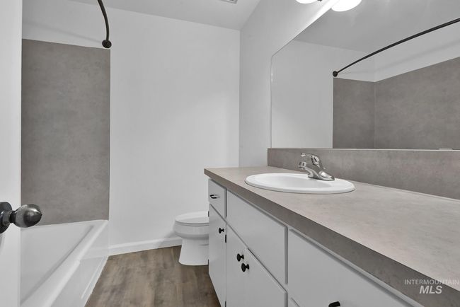 Bathroom featuring vanity, wood finished floors, and shower / tub combination | Image 17
