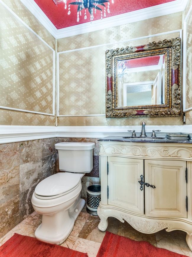 Half bath featuring vanity and marble finish flooring | Image 8