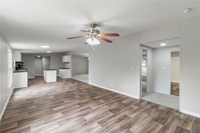 Unfurnished living room featuring recessed lighting, wood finished floors, a ceiling fan, and baseboards | Image 7