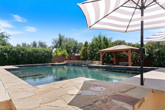 Backyard Oasis with Sparkling Pool, Pergola, and Outdoor Kitchen | Image 4