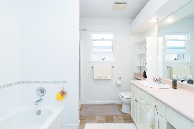 Full bath with a garden tub, vanity, healthy amount of natural light, and toilet | Image 21