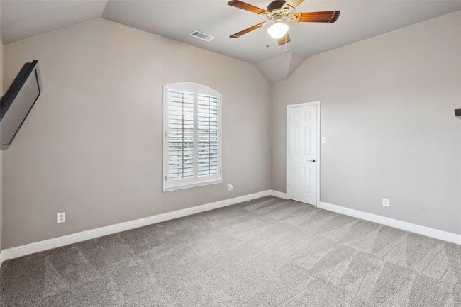 Spare room with ceiling fan, light carpet, and vaulted ceiling | Image 31
