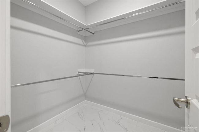 Spacious closet featuring marble finish floors | Image 14