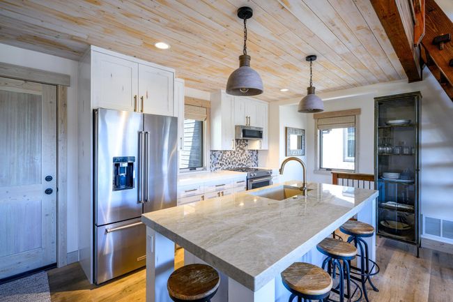 Spacious kitchen island offering plenty of seating | Image 12