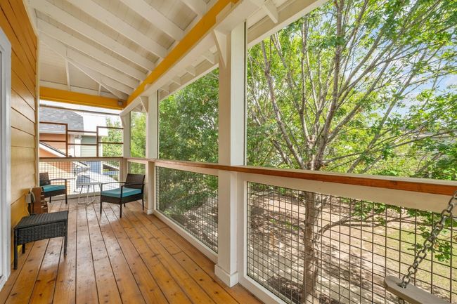 The screened-in balcony provides a peaceful haven, where you can relax and enjoy the view in comfort, making it your perfect outdoor retreat year-round | Image 22
