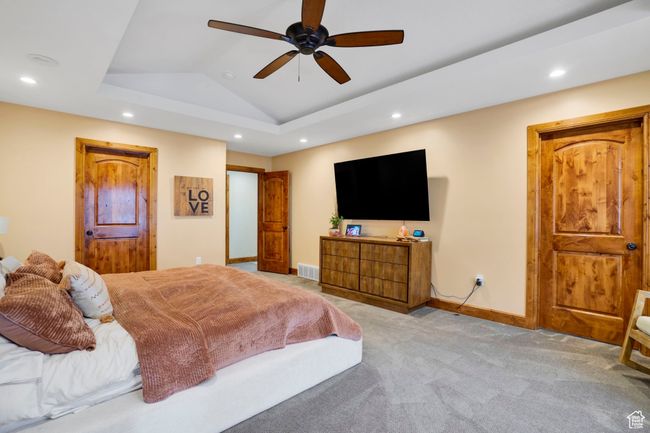 Bedroom with carpet floors, a ceiling fan, lofted ceiling, baseboards, and recessed lighting | Image 17
