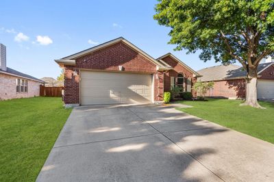 View of front of house with a front yard and a garage | Image 2