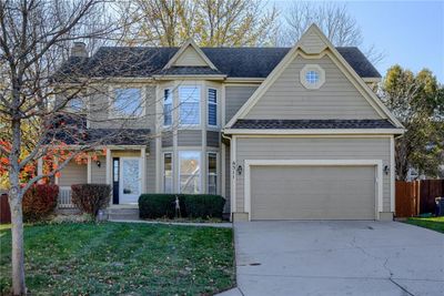 View of front facade featuring a garage and a front yard | Image 1