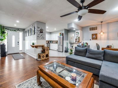 Living room featuring a wealth of natural light, ceiling fan, and hardwood / wood-style flooring | Image 2