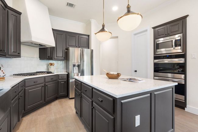 High-end stainless steel appliances elevate the cooking experience, combining performance with style in a sleek, modern package. | Image 10