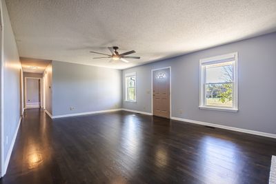 Shiny hardwood floors greet you upon your entry. | Image 2