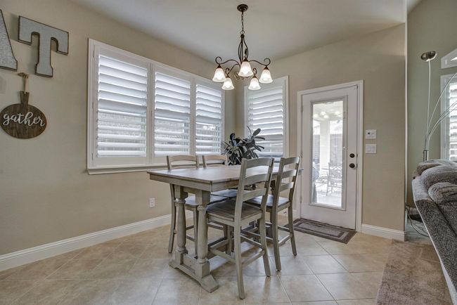 Dining room with plenty of natural light, a chandelier, and light tile patterned floors | Image 10