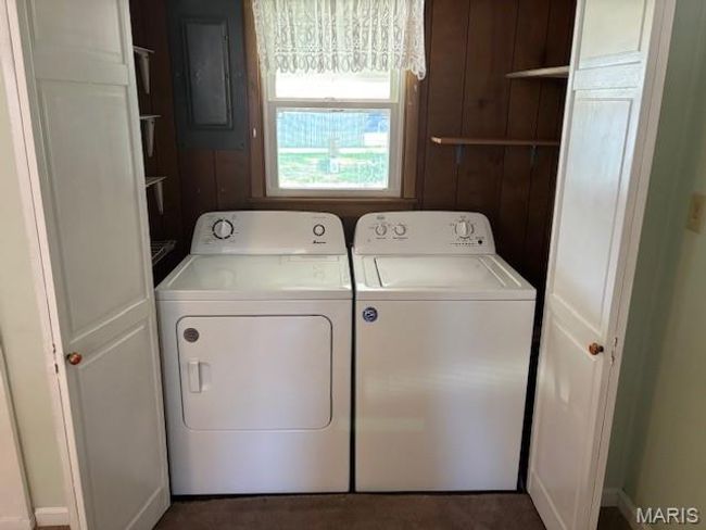 Laundry room featuring washing machine and dryer and electric panel | Image 32