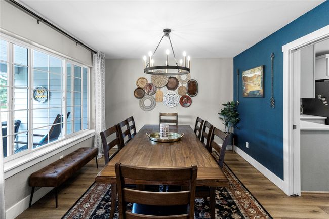 Dining room featuring a chandelier and wood finished floors | Image 7