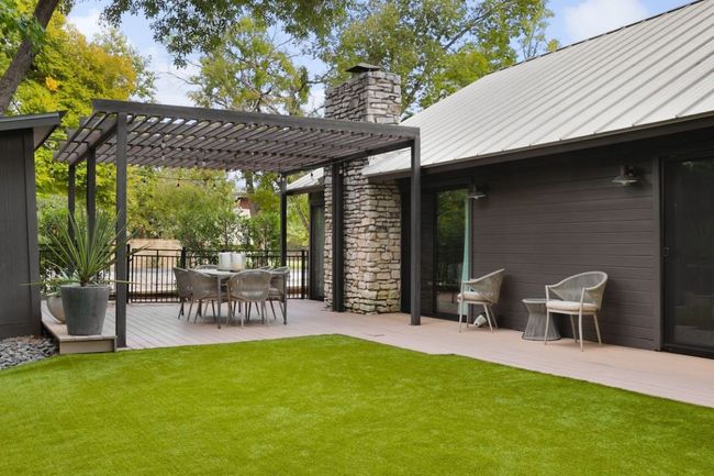 View of yard featuring a pergola, outdoor dining space, and a wooden deck | Image 30
