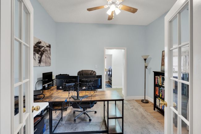 Office with french doors, wood finished floors, and a ceiling fan | Image 19