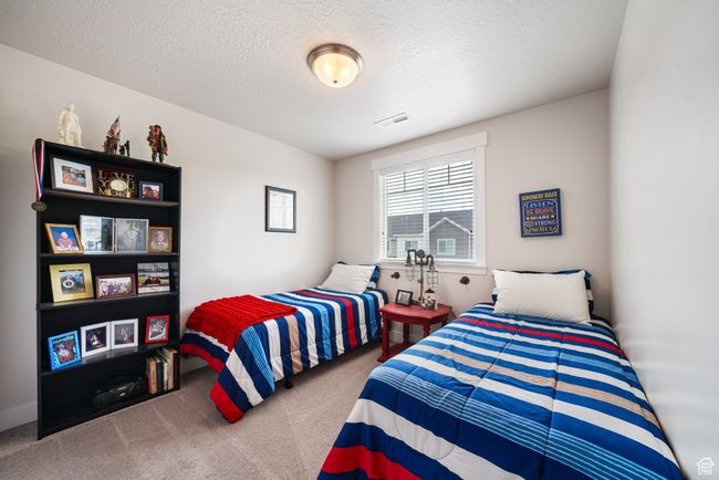 Bedroom with carpet flooring and a textured ceiling | Image 22