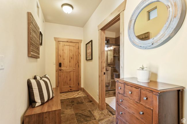 Entryway featuring baseboards and dark stone finish floors | Image 16