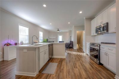 Kitchen with white cabinets and appliances with stainless steel finishes | Image 3