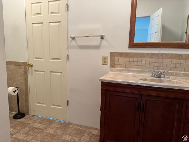 Bathroom with vanity and tile walls | Image 23
