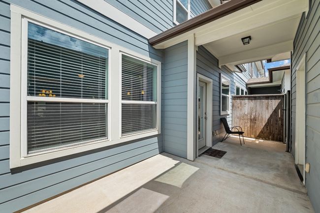 The private, partially covered back patio offers a serene spot to relax, whether you're enjoying morning coffee or hosting a quiet evening | Image 34