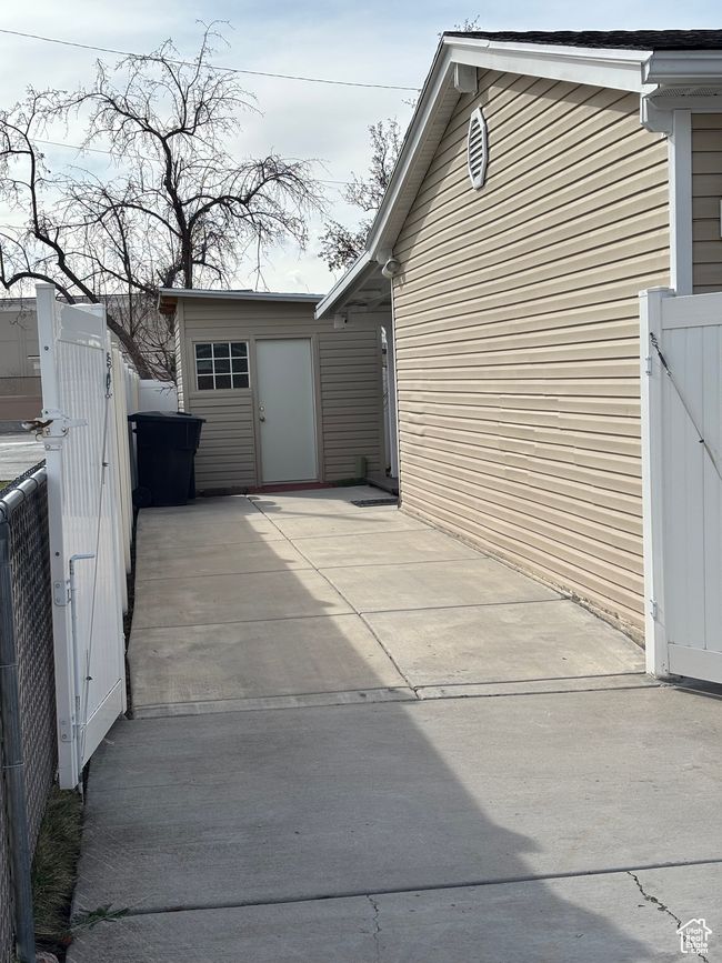 View of side of home with a gate and fence | Image 18