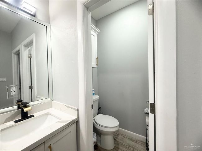 Bathroom with vanity, toilet, and wood finished floors | Image 10