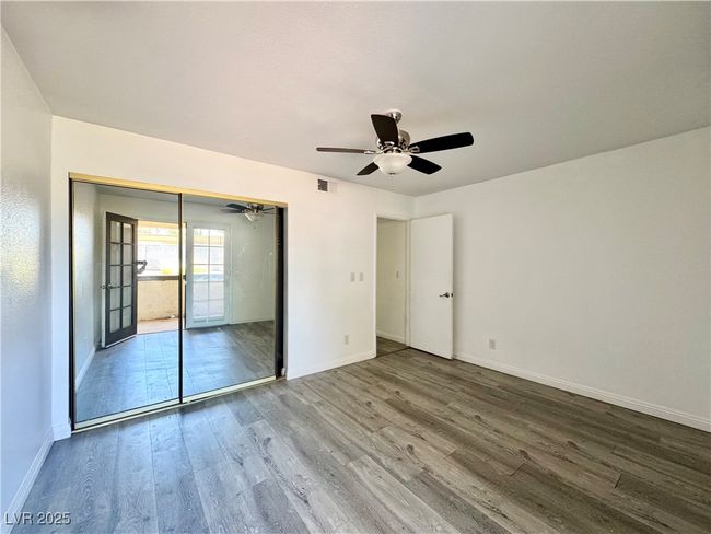 Secondary Unfurnished bedroom with wood finished floors, a closet, and ceiling fan | Image 25