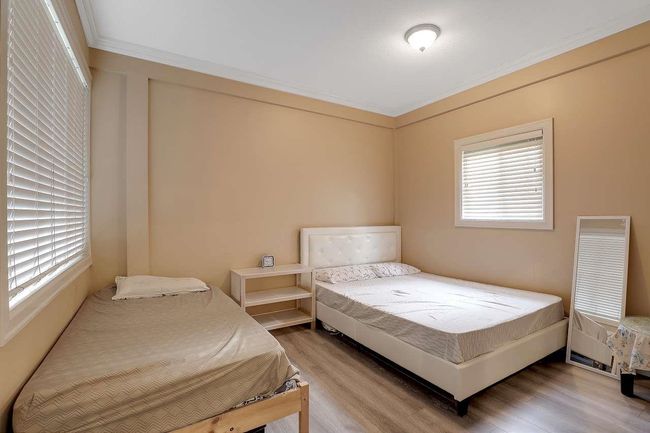 Bedroom with wood finished floors and ornamental molding | Image 39