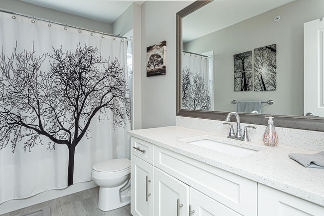 Full bath featuring toilet, vanity, wood finished floors, and curtained shower | Image 10