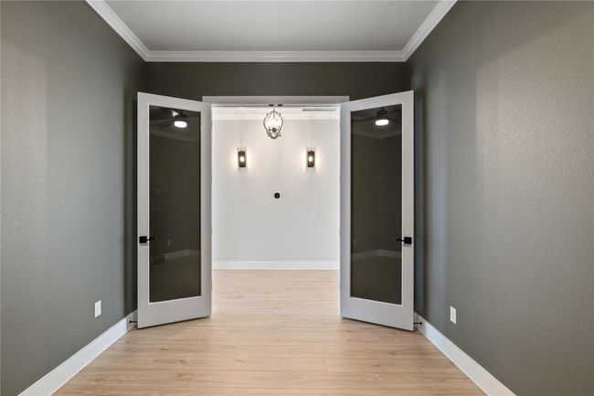 Unfurnished room featuring light wood-type flooring, ornamental molding, and french doors | Image 27