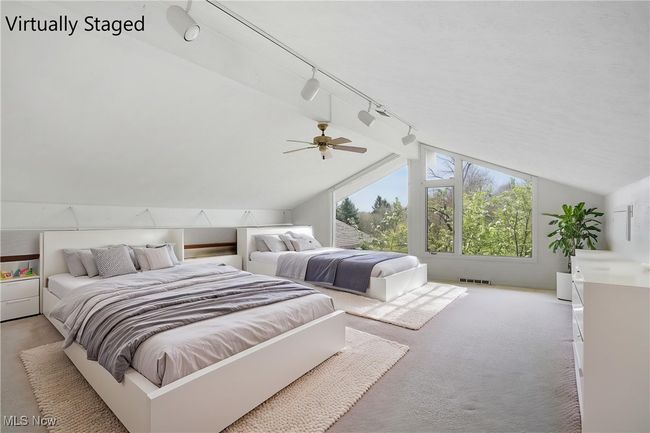 Bedroom with visible vents, light colored carpet, lofted ceiling, a ceiling fan, and rail lighting | Image 22