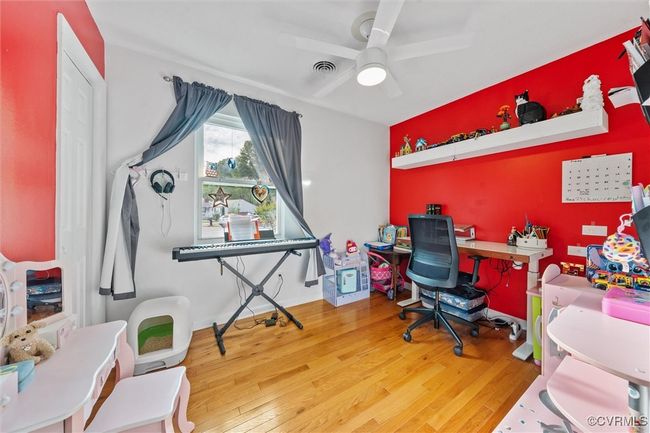 Office with visible vents, wood finished floors, and ceiling fan | Image 26