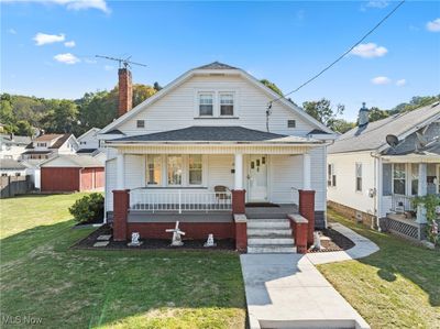 Bungalow with a porch and a front lawn | Image 1