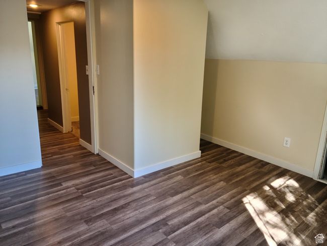 Spare room featuring dark wood-style flooring and baseboards | Image 22