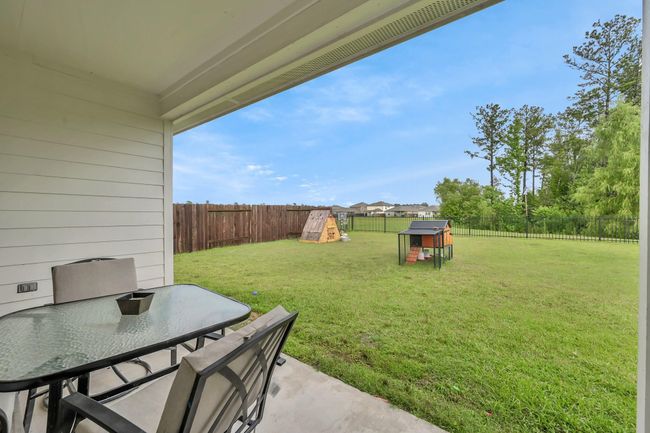 Heading outside you'll see that you have a spacious covered back patio calling your name. The wrought iron fence at the back really capitalizes on the view! | Image 32