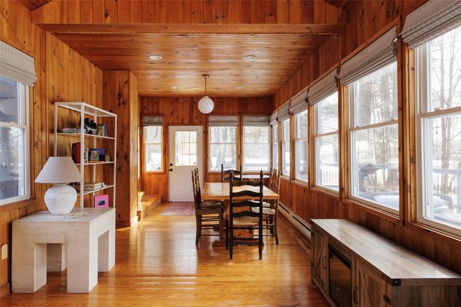 Dining space with wood ceiling, a healthy amount of sunlight, light hardwood / wood-style floors, and wood walls | Image 23