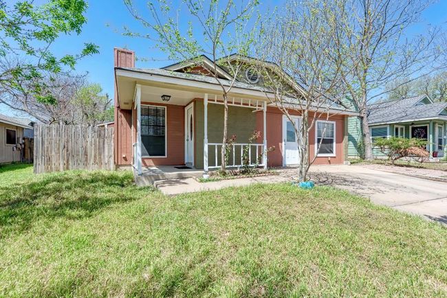 View of front of house with a front yard, fence, covered porch, and a chimney | Image 4