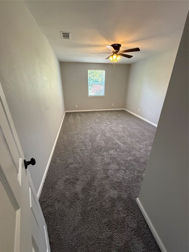 Carpeted spare room featuring a ceiling fan | Image 10
