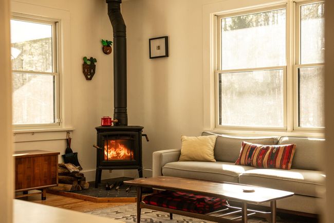 Living area featuring hardwood / wood-style floors and a wood stove | Image 4