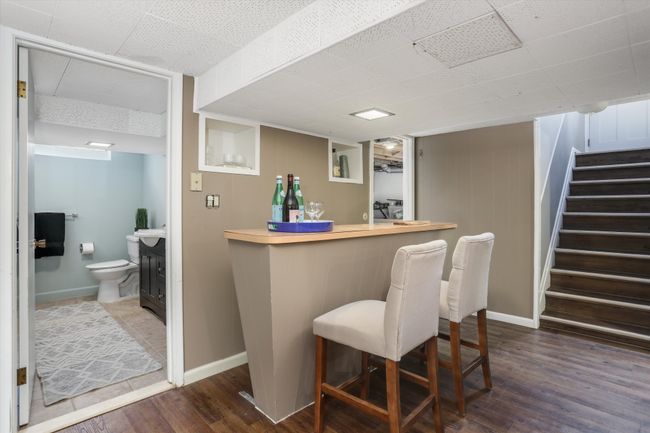 Basement features custom bar and powder room | Image 15