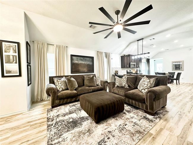 Living room with abundant natural light, high ceilings, and sight lines for an open, luxurious space. | Image 4